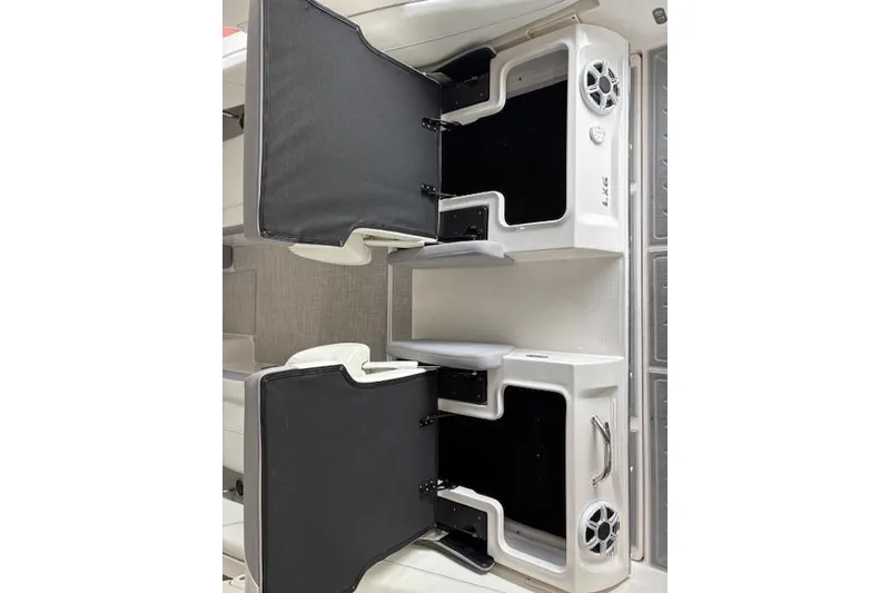 Slide: The Image of 2026 Regal LX6 boat interior with open storage compartments and speaker system. - 5
