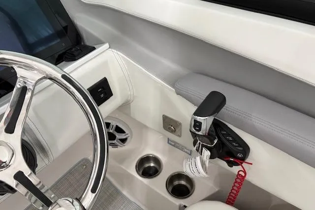 Slide: The Image of Interior of 2026 Regal LX6 boat featuring steering wheel and control panel. - 6