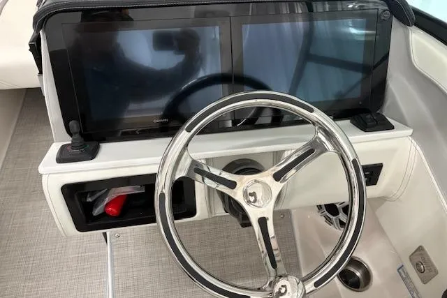 Slide: The Image of Steering wheel and dual screens on 2026 Regal LX6 boat dashboard. - 7