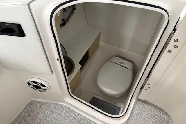 Slide: The Image of 2026 Regal LX6 boat interior with compact marine toilet and speaker. - 9