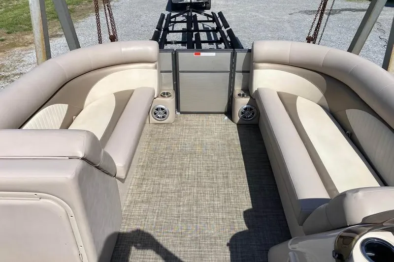 Slide: The Image of Interior of a 2015 Crest 230 boat with beige seating and carpeted floor. - 3