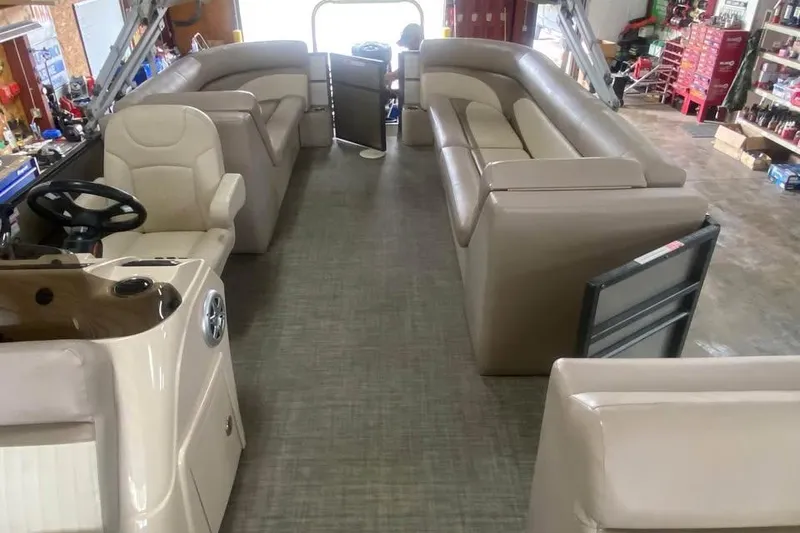 Slide: The Image of Interior of a 2015 Crest 230 boat with beige seating and steering console. - 4