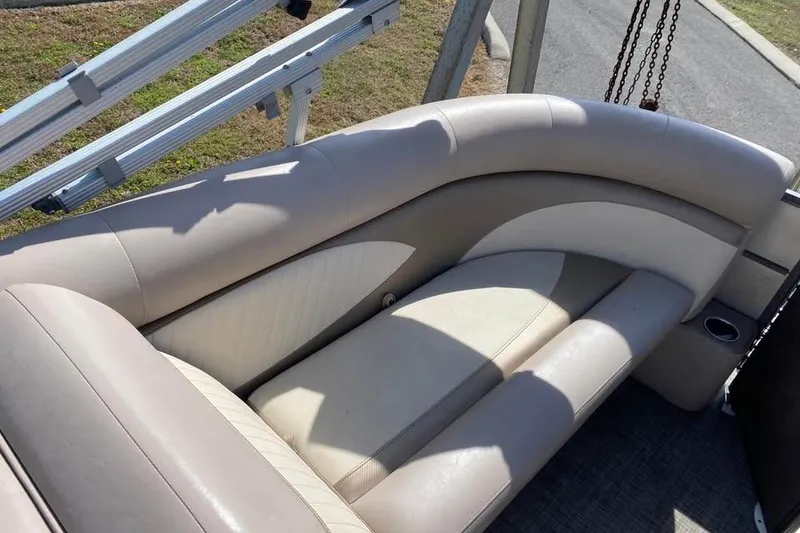 Slide: The Image of Beige seating on 2015 Crest 230 boat, featuring curved design and cup holder. - 5