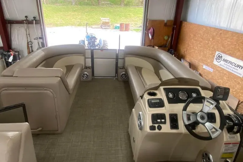 Slide: The Image of Interior of a 2015 Crest 230 pontoon boat with beige seating and steering console. - 6