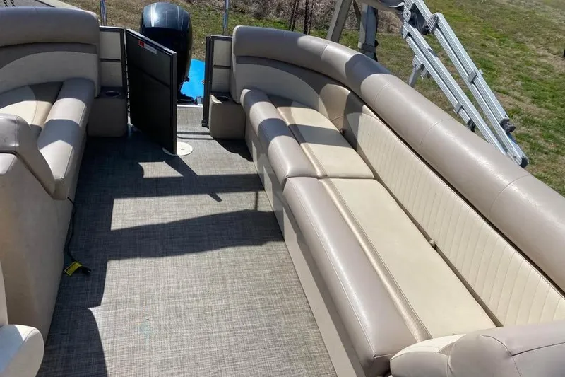 Slide: The Image of Interior of a 2015 Crest 230 boat with beige seating and carpeted floor. - 7