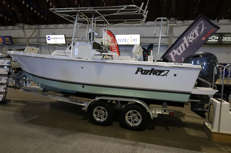 The Image of 2026 Parker 210 Coastal boat displayed indoors on a trailer. - 0