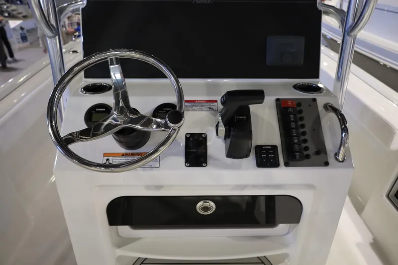 Slide: The Image of Control panel of 2026 Parker 210 Coastal boat with steering wheel and switches. - 11