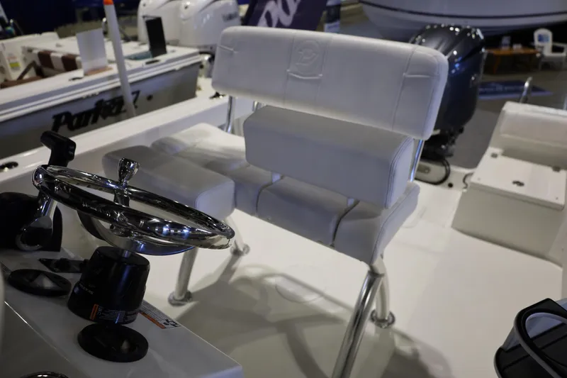 Slide: The Image of 2026 Parker 210 Coastal boat interior with steering wheel and white seating. - 17
