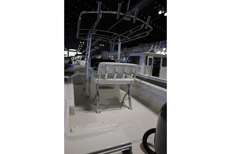 Slide: The Image of 2026 Parker 210 Coastal boat interior with seating and T-top in showroom. - 18