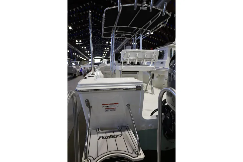 Slide: The Image of 2026 Parker 210 Coastal boat interior with seating and equipment, showcased indoors. - 19