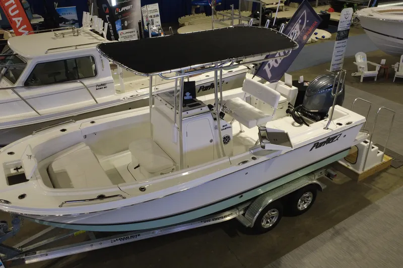 Slide: The Image of 2026 Parker 210 Coastal boat displayed indoors on a trailer. - 4