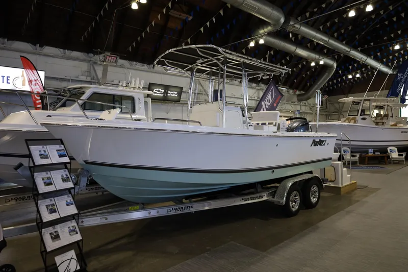 Slide: The Image of 2026 Parker 210 Coastal boat displayed indoors on a trailer. - 6