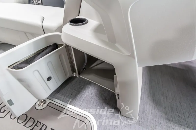 Slide: The Image of 2026 Godfrey Sweetwater 2286 SBC boat interior storage compartment with cup holder. - 10