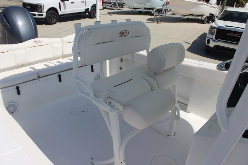 Slide: The Image of 2019 Sea Hunt Ultra 234 boat interior with white seating and helm station. - 11