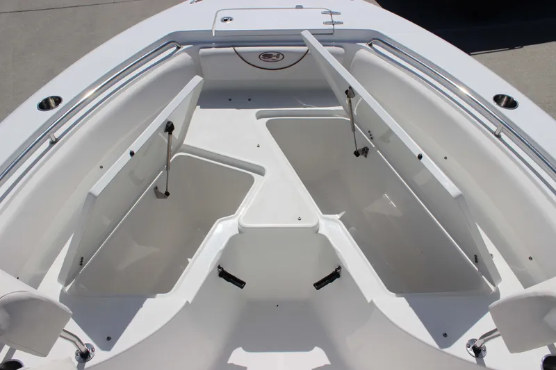 Slide: The Image of 2019 Sea Hunt Ultra 234 boat with open storage compartments on deck. - 14