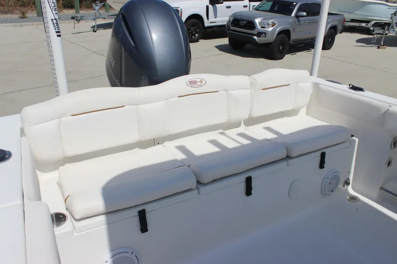 Slide: The Image of 2019 Sea Hunt Ultra 234 boat interior with cushioned seating and Yamaha engine. - 17