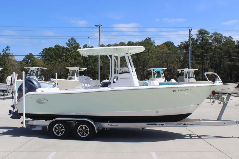 The Image of 2019 Sea Hunt Ultra 234 boat on trailer in parking lot. - 2