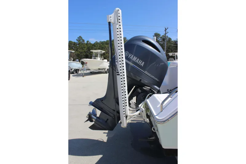 Slide: The Image of 2019 Sea Hunt Ultra 234 boat with Yamaha outboard motor, parked outdoors. - 4