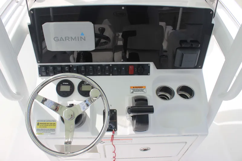 Slide: The Image of 2019 Sea Hunt Ultra 234 boat dashboard with Garmin navigation system and steering wheel. - 8