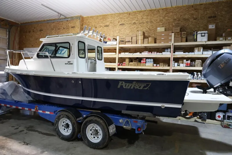 The Image of 2026 Parker 227 Explorer boat on trailer in a storage facility. - 0