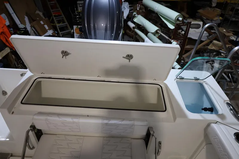 Slide: The Image of Open storage compartment on 2026 Parker 227 Explorer boat, showcasing interior features. - 13