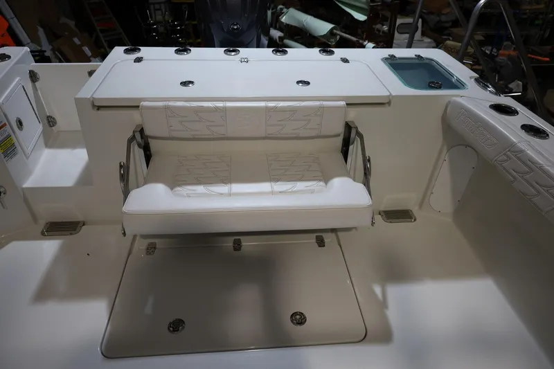 Slide: The Image of 2026 Parker 227 Explorer boat interior with white cushioned seating and storage compartments. - 14