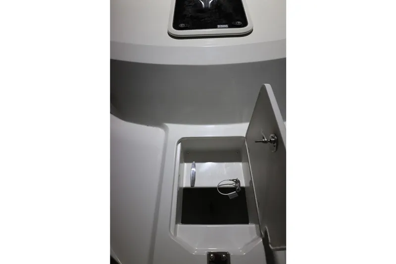 Slide: The Image of Interior storage compartment of 2026 Parker 227 Explorer boat, featuring sleek design and secure latch. - 5