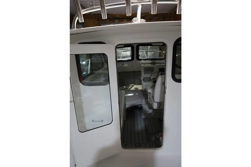 Slide: The Image of Interior view of 2026 Parker 227 Explorer boat, showcasing helm and seating area. - 6
