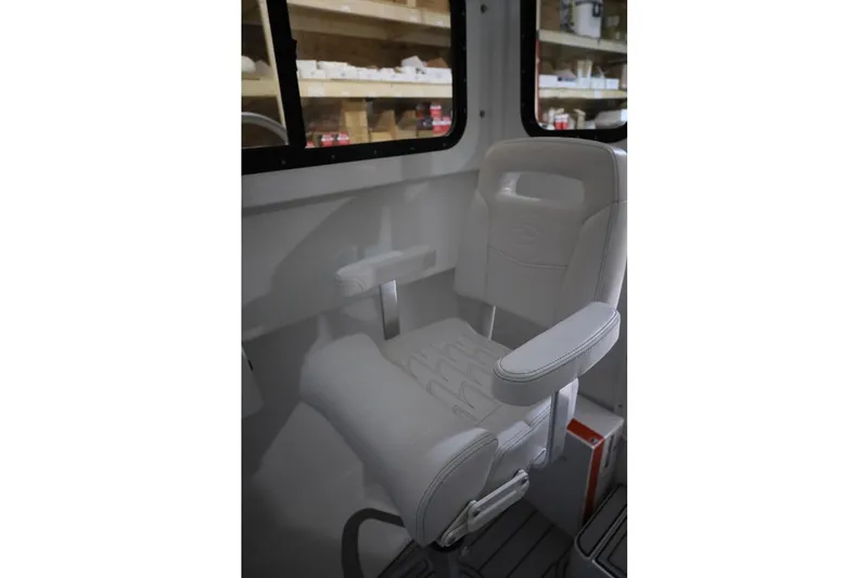 Slide: The Image of White captain's chair inside 2026 Parker 227 Explorer boat cabin. - 7
