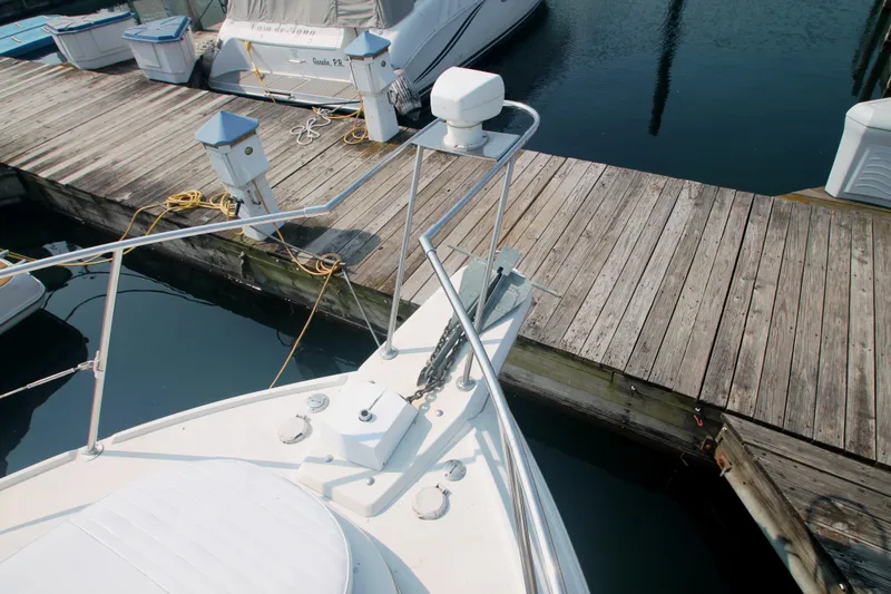 Slide: The Image of Bow of 1996 Carver 330 Mariner docked at marina with wooden pier. - 11