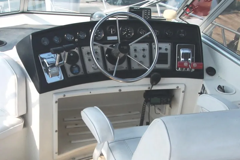 Slide: The Image of 1996 Carver 330 Mariner helm with steering wheel and control panel. - 18