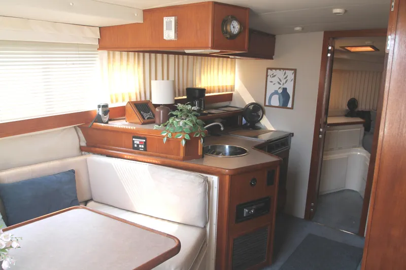 Slide: The Image of Interior of 1996 Carver 330 Mariner yacht with kitchenette and dining area. - 32