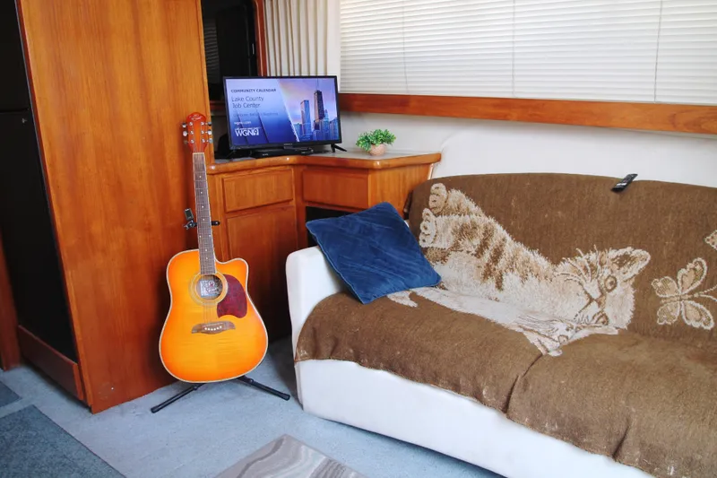 Slide: The Image of Interior of 1996 Carver 330 Mariner with guitar, TV, and cozy sofa. - 35