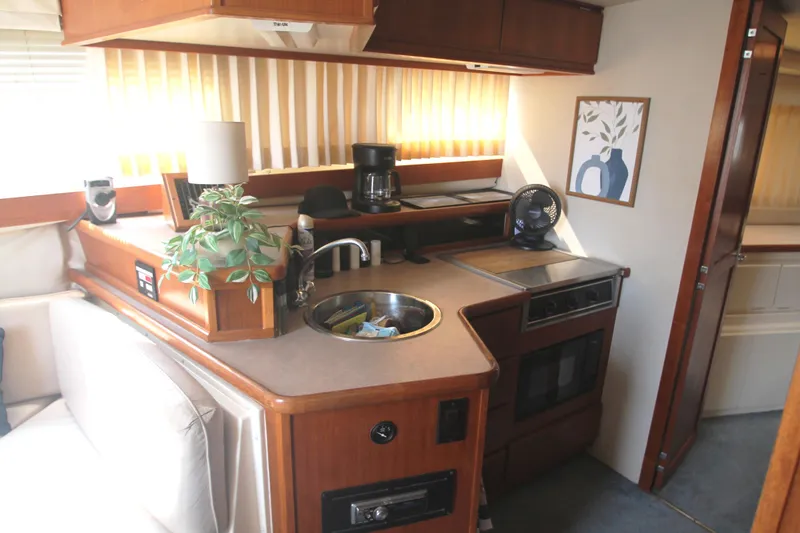 Slide: The Image of Interior of a 1996 Carver 330 Mariner yacht kitchen with appliances and decor. - 37