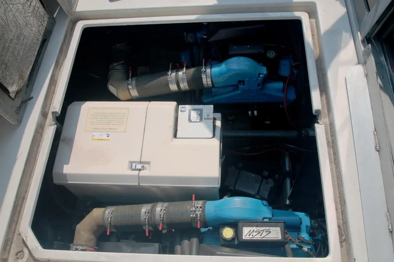 Slide: The Image of Engine compartment of a 1996 Carver 330 Mariner boat, showcasing mechanical components. - 51