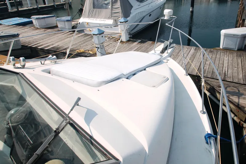 Slide: The Image of 1996 Carver 330 Mariner boat docked at marina, featuring spacious deck and sleek design. - 7