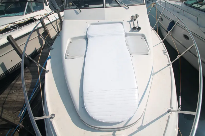 Slide: The Image of 1996 Carver 330 Mariner boat deck with sunpad and railing. - 8