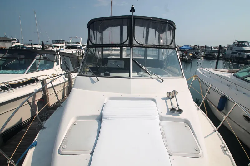 Slide: The Image of 1996 Carver 330 Mariner yacht docked at a marina, surrounded by other boats. - 9