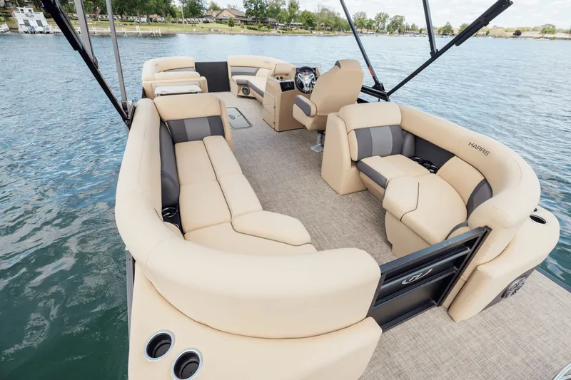 Slide: The Image of 2026 Harris Cruiser 230 pontoon boat with beige seating on a calm lake. - 34