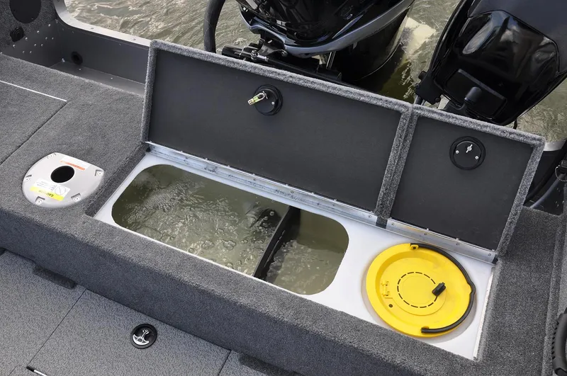 Slide: The Image of Manufacturer Provided Image: 2019 Lund 2175 Pro-V boat with open storage compartments and motor in water. - 10