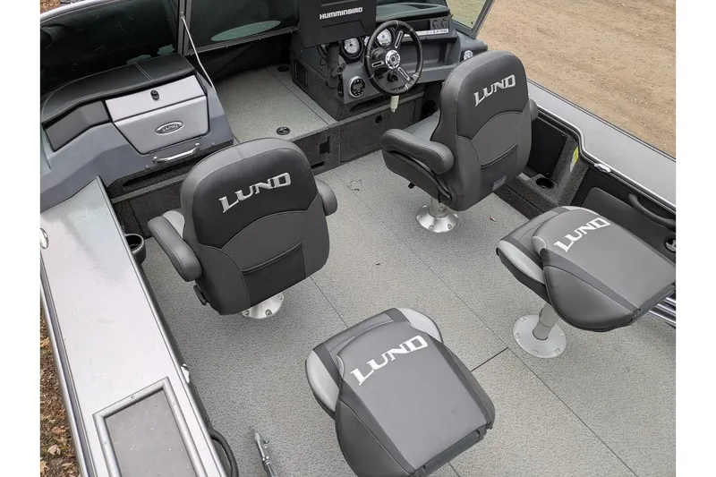 Slide: The Image of 2019 Lund 2175 Pro-V boat interior with four branded seats and steering console. - 3