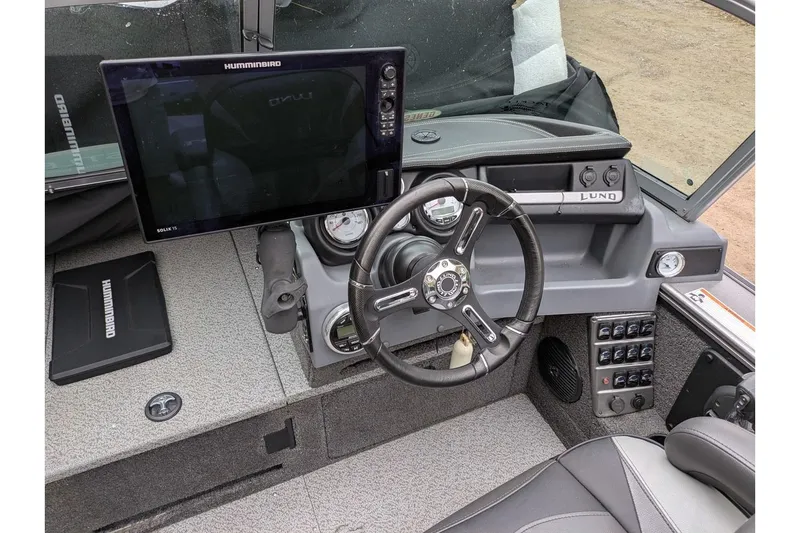 Slide: The Image of 2019 Lund 2175 Pro-V boat dashboard with steering wheel and Humminbird electronics. - 5