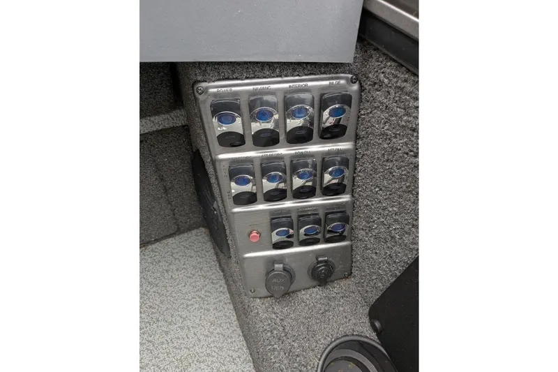 Slide: The Image of Control panel of a 2019 Lund 2175 Pro-V boat with multiple switches and outlets. - 6