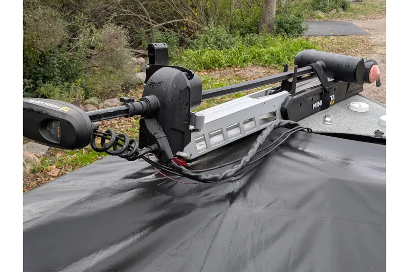 Slide: The Image of 2019 Lund 2175 Pro-V boat with Minn Kota trolling motor in a wooded area. - 7