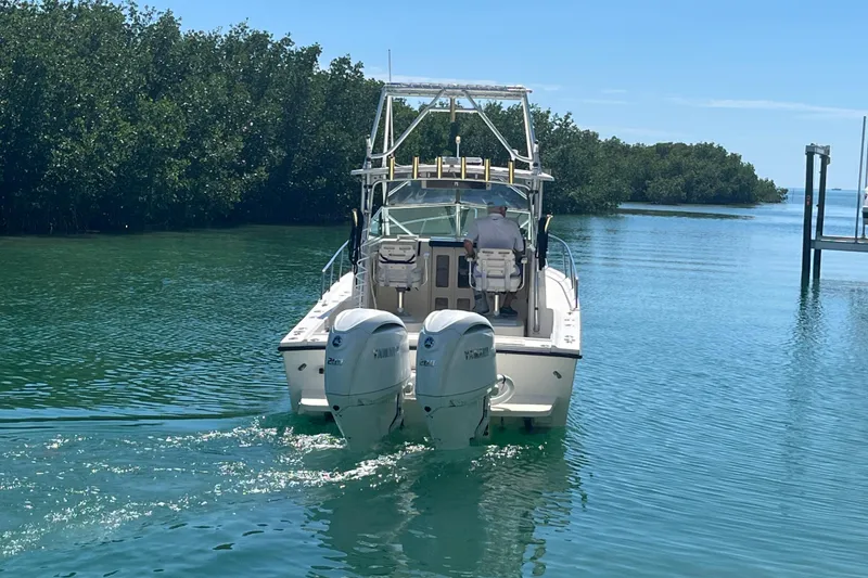 Slide: The Image of 2005 Parker 2510 Modified Vee Walkaround boat cruising in clear waters. - 5