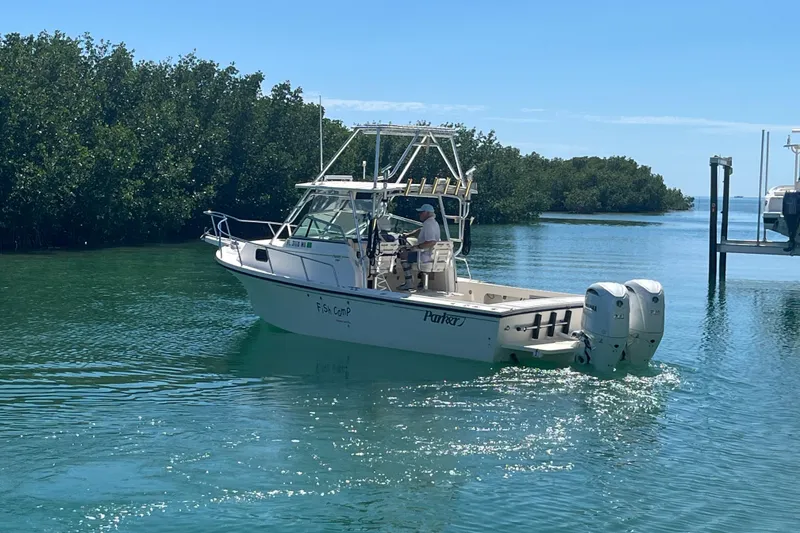 Slide: The Image of 2005 Parker 2510 Modified Vee Walkaround boat cruising in clear waters near mangroves. - 6