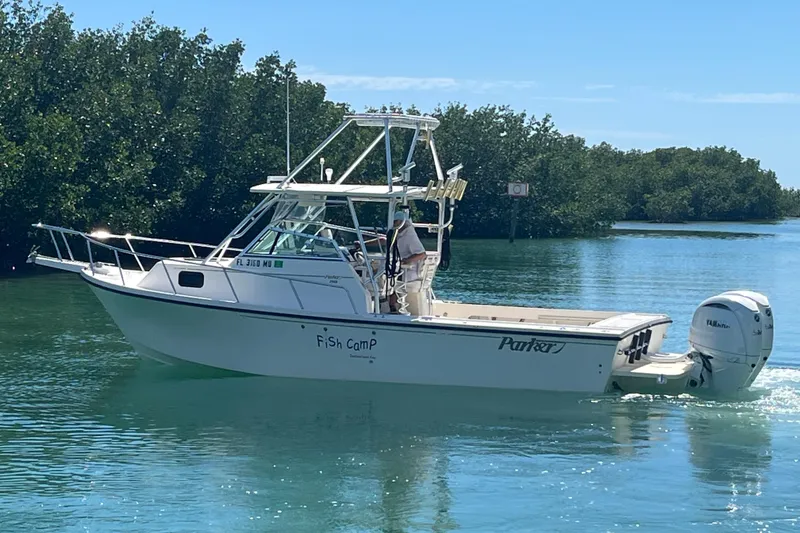 Slide: The Image of 2005 Parker 2510 Modified Vee Walkaround boat cruising on clear water near mangroves. - 7