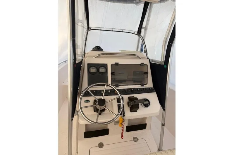 The Image of Center console of a 2002 Grady-White Fisherman 222 boat with steering wheel and controls. - 1