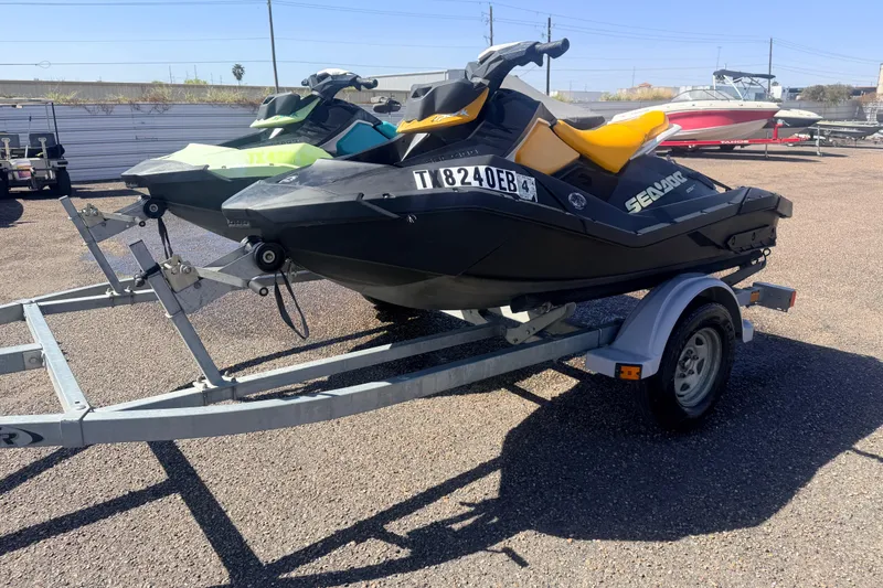 Slide: The Image of 2018 Sea-Doo Spark 2up jet ski on trailer in sunny outdoor setting. - 1
