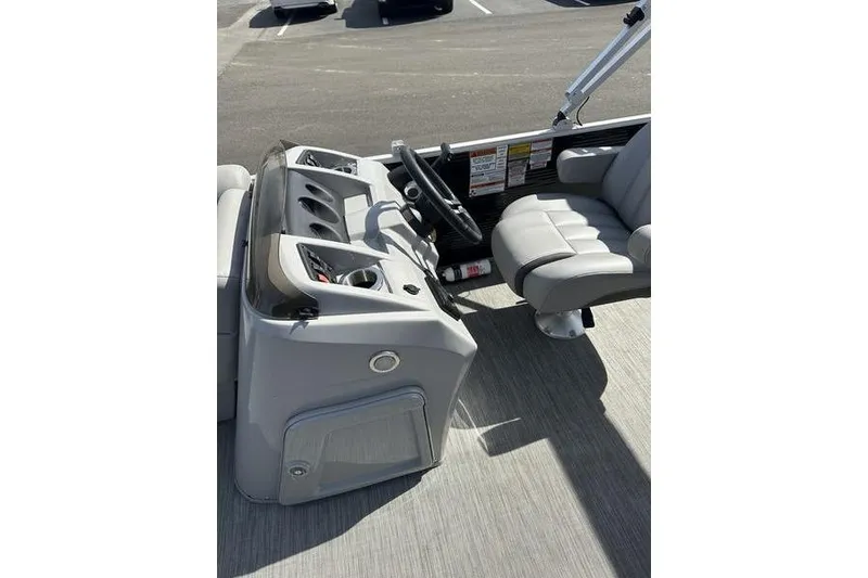 Slide: The Image of 2020 Bennington 21 SL boat interior with steering console and seating. - 11